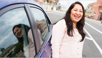 An ASU Uber scholar stands next to her vehicle.