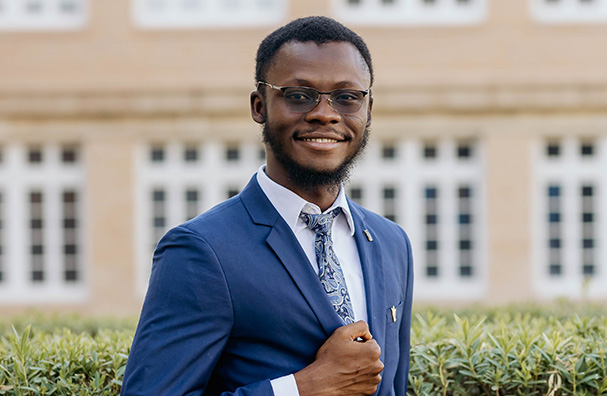 man with glasses wearing a blue suit