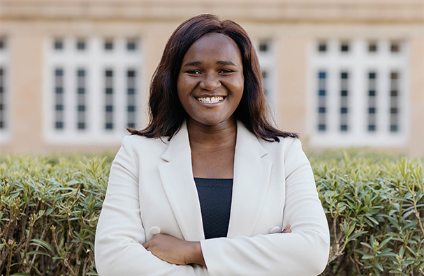 woman in a white blazer smiling