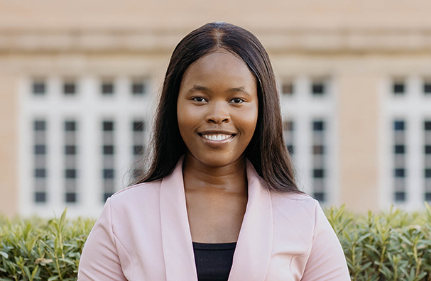 woman wearing a pink blazer smiling